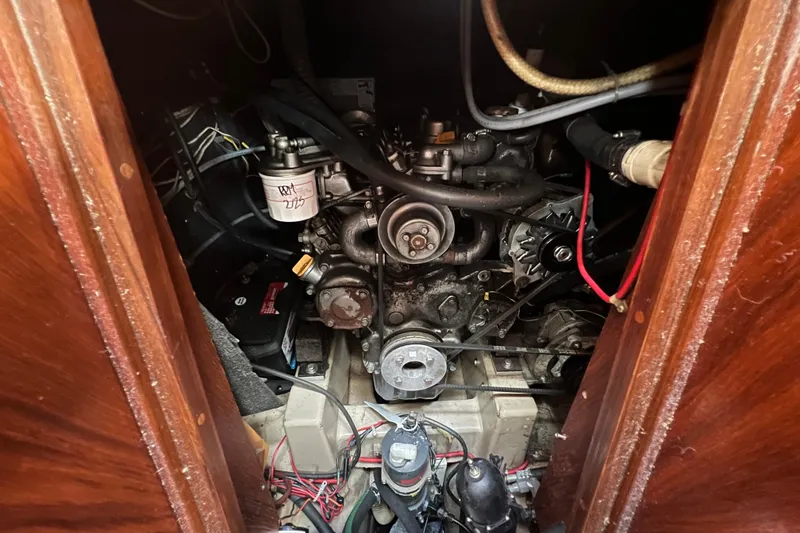 Slide: The Image of Engine compartment of a 1985 C&C Landfall 39 sailboat, showing mechanical components and wiring. - 51