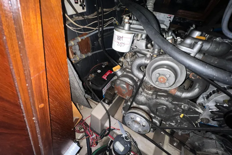 Slide: The Image of Engine compartment of a 1985 C&C Landfall 39 sailboat, showing mechanical components and wiring. - 53