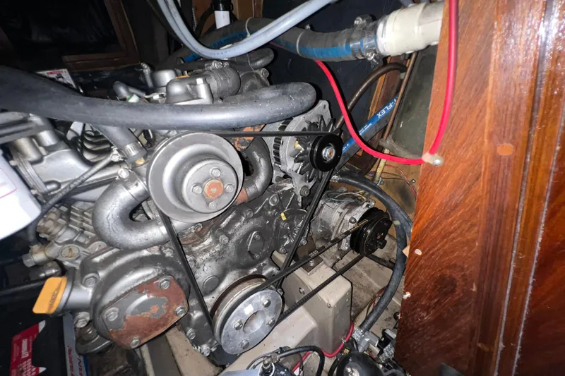 Slide: The Image of Engine compartment of a 1985 C&C Landfall 39 sailboat, showing mechanical components and belts. - 54