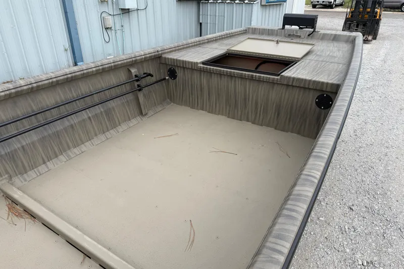 Slide: The Image of 2026 Gator Tail 1754 Extreme boat interior with open storage compartment, parked on gravel. - 5