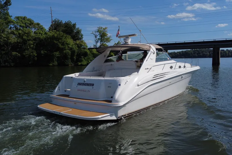 Slide: The Image of 1997 Sea Ray 450 Sundancer yacht cruising on a sunny day near a bridge. - 22