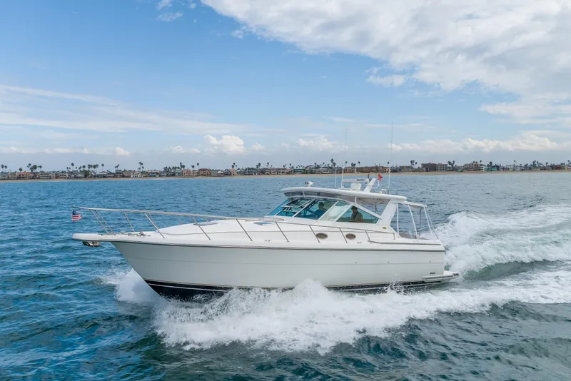 Slide: The Image of 2004 Tiara Yachts 4000 Express cruising on open water under a partly cloudy sky. - 11