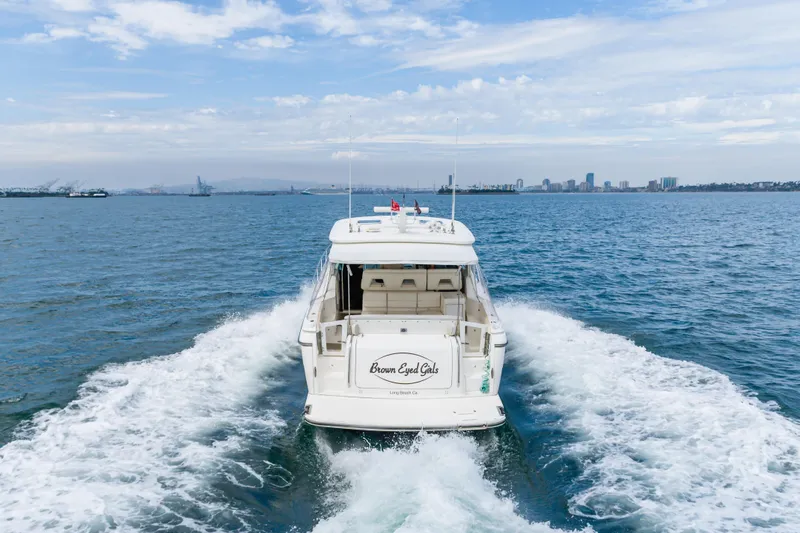 Slide: The Image of 2004 Tiara Yachts 4000 Express cruising on open water with city skyline in background. - 12