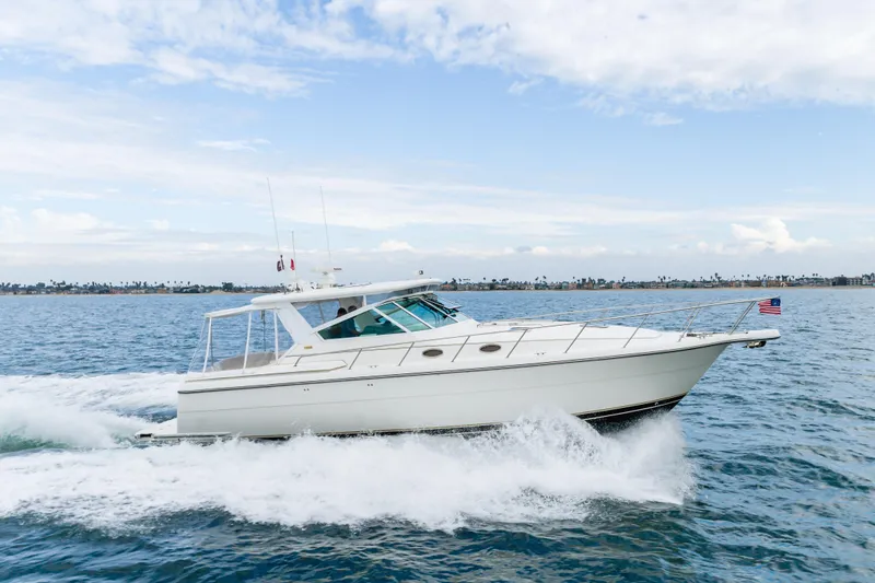 Slide: The Image of 2004 Tiara Yachts 4000 Express cruising on open water under a clear sky. - 18
