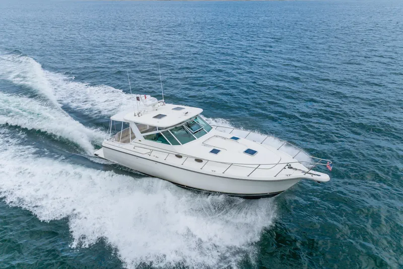 Slide: The Image of 2004 Tiara Yachts 4000 Express cruising on open water, showcasing sleek design and performance. - 19