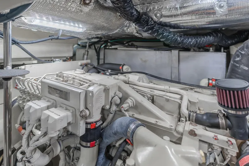 Slide: The Image of Engine room of 2004 Tiara Yachts 4000 Express, showcasing mechanical components and wiring. - 25