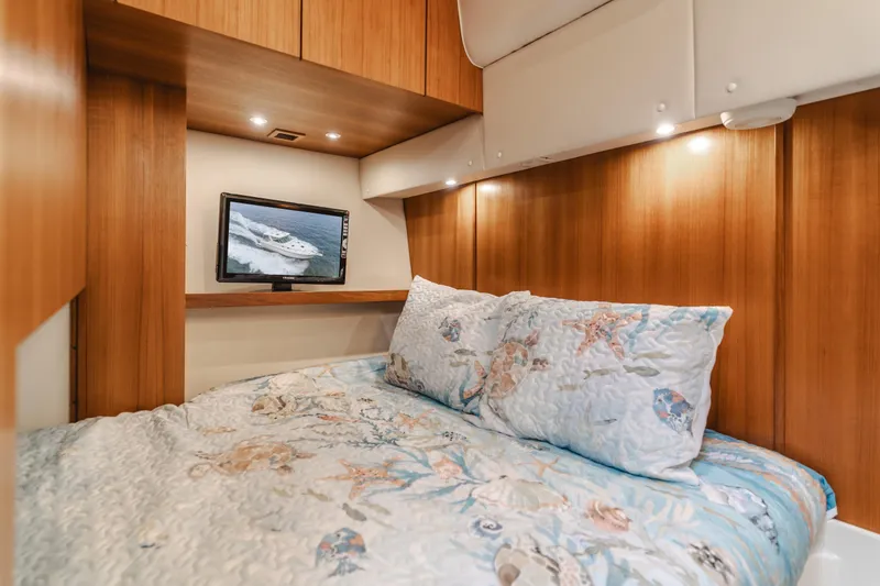Slide: The Image of Cozy cabin interior of 2004 Tiara Yachts 4000 Express with nautical-themed bedding. - 27