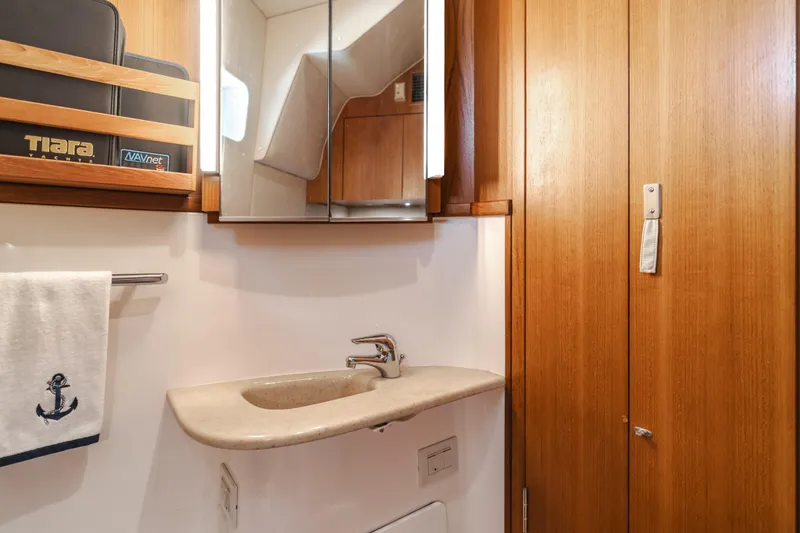 Slide: The Image of 2004 Tiara Yachts 4000 Express bathroom with wooden cabinetry and modern sink. - 30