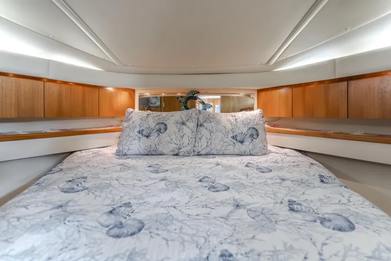 Slide: The Image of Luxurious cabin interior of 2004 Tiara Yachts 4000 Express with nautical-themed bedding. - 31