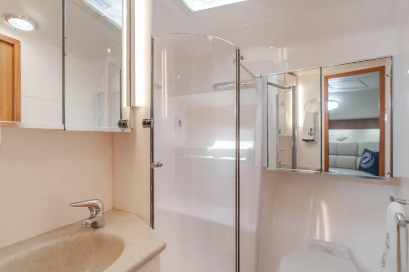 Slide: The Image of Luxurious bathroom in 2004 Tiara Yachts 4000 Express, featuring modern fixtures and elegant design. - 34