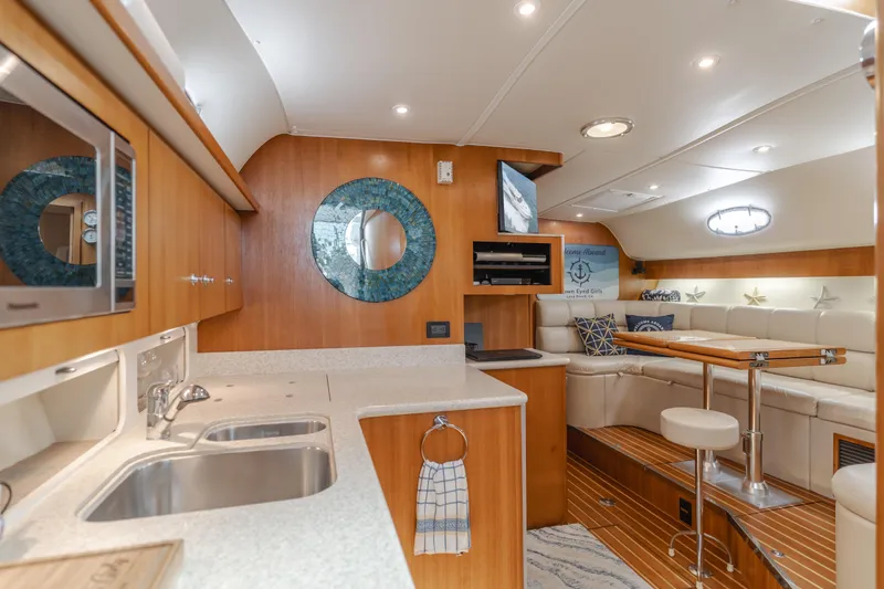 Slide: The Image of Luxurious interior of 2004 Tiara Yachts 4000 Express with modern kitchen and cozy seating area. - 41