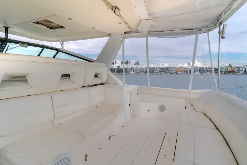 Slide: The Image of 2004 Tiara Yachts 4000 Express interior with white seating and waterfront view. - 43