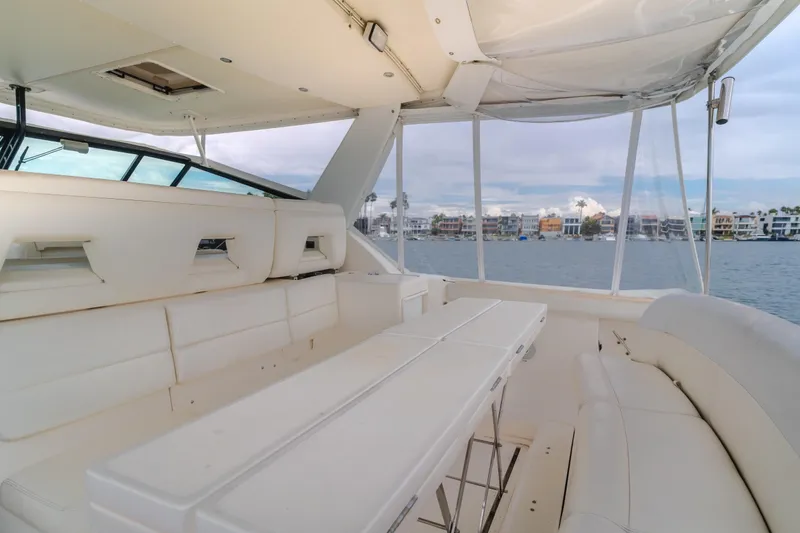 Slide: The Image of 2004 Tiara Yachts 4000 Express interior with white seating and waterfront view. - 44