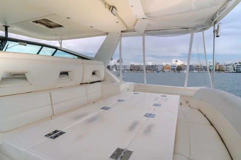 Slide: The Image of 2004 Tiara Yachts 4000 Express interior with white seating and waterfront view. - 45
