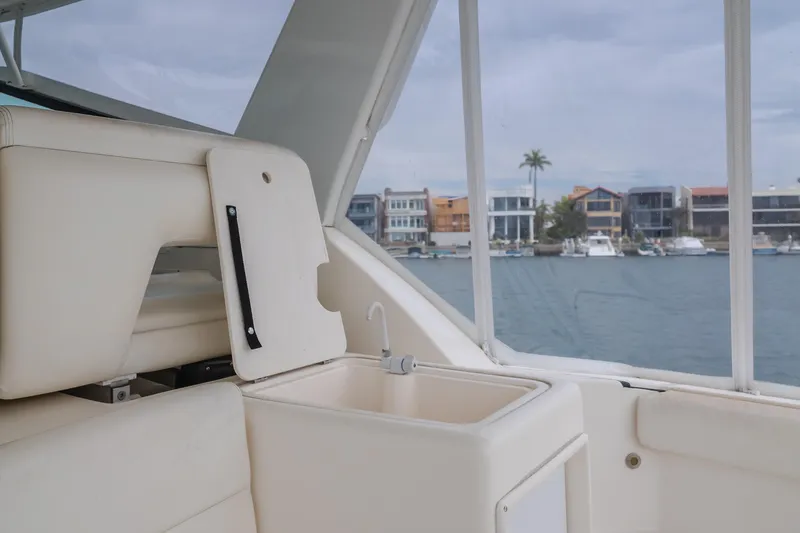 Slide: The Image of 2004 Tiara Yachts 4000 Express interior with sink, overlooking waterfront homes. - 47