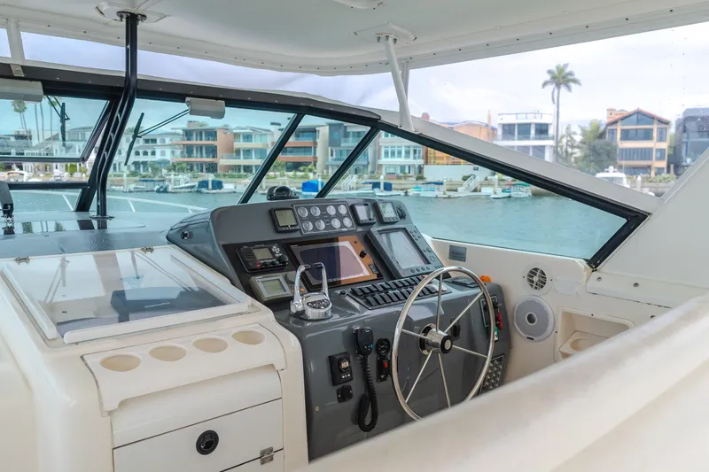 Slide: The Image of 2004 Tiara Yachts 4000 Express helm with modern controls and waterfront view. - 49