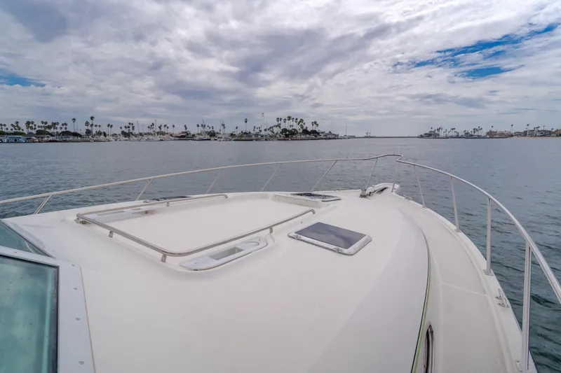 Slide: The Image of 2004 Tiara Yachts 4000 Express cruising on calm waters under cloudy skies. - 51