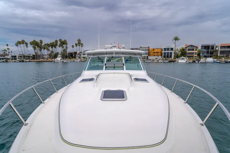 Slide: The Image of 2004 Tiara Yachts 4000 Express on water, with coastal homes and palm trees in background. - 52