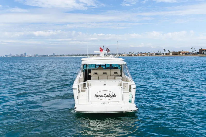 Slide: The Image of 2004 Tiara Yachts 4000 Express on open water, city skyline in background. - 6