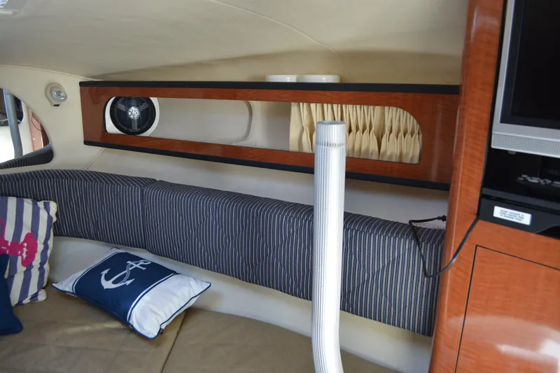 Slide: The Image of Interior of 2005 Sea Ray 280 Sundancer with cushions and nautical-themed pillows. - 20