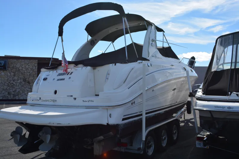 Slide: The Image of 2005 Sea Ray 280 Sundancer boat on trailer, parked outdoors under clear sky. - 4