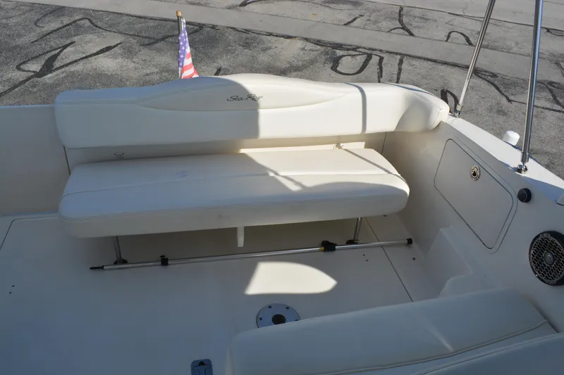 Slide: The Image of 2005 Sea Ray 280 Sundancer boat interior with white seating and American flag. - 6