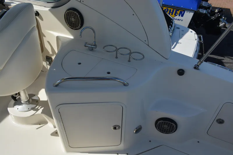 Slide: The Image of 2005 Sea Ray 280 Sundancer cockpit with sink and cup holders. - 8