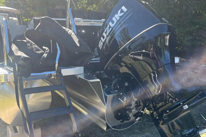 Slide: The Image of 2026 Avalon 23 LSZ Elite with Suzuki outboard motor in sunlight. - 6