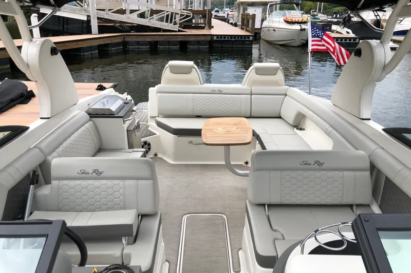 Slide: The Image of 2020 Sea Ray SDX 290 boat interior with luxurious seating and American flag. - 13