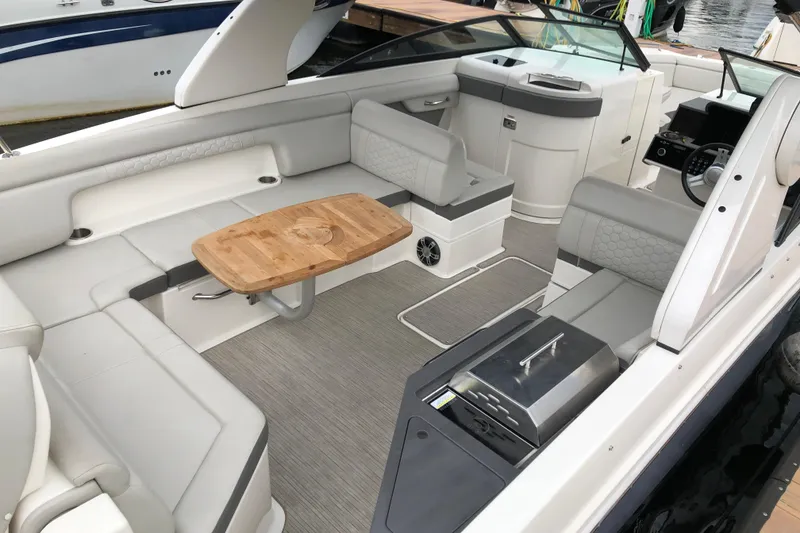 Slide: The Image of 2020 Sea Ray SDX 290 boat interior with seating, table, and helm. - 4