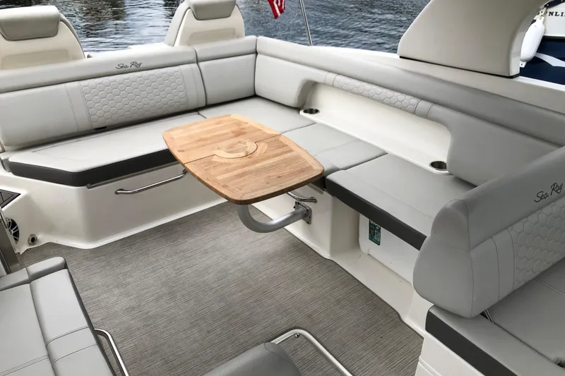 Slide: The Image of Luxurious 2020 Sea Ray SDX 290 boat interior with elegant seating and wooden table. - 8