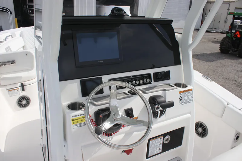 Slide: The Image of 2026 Sea Fox 248 Commander boat dashboard with steering wheel and control panel. - 16