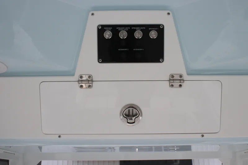 Slide: The Image of Control panel of 2026 Sea Fox 248 Commander boat with switches and storage compartment. - 18