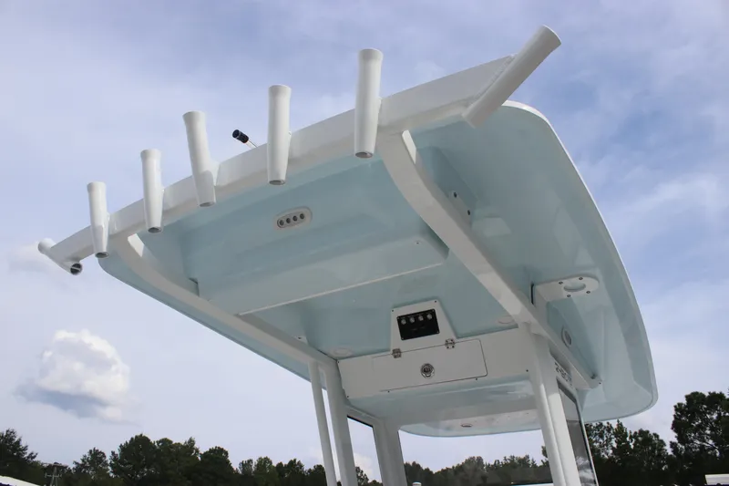 Slide: The Image of 2026 Sea Fox 248 Commander boat top with rod holders against a blue sky. - 19
