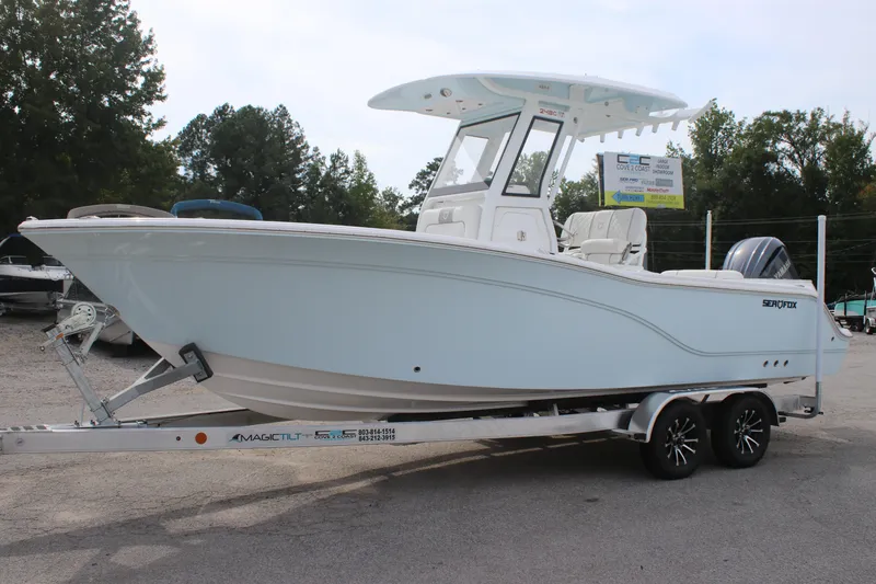 Slide: The Image of 2026 Sea Fox 248 Commander boat on trailer, parked outdoors. - 3
