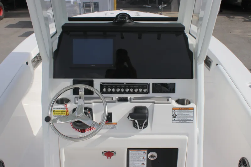 Slide: The Image of 2026 Sea Fox 248 Commander boat dashboard with steering wheel and control panel. - 8