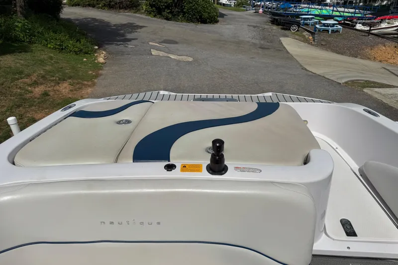 Slide: The Image of 2004 Correct Craft Air Nautique 226 boat interior with cushioned seating and sleek design. - 10