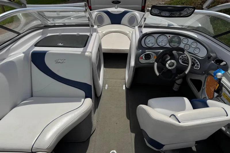 Slide: The Image of 2004 Correct Craft Air Nautique 226 boat interior with steering wheel and seating. - 4