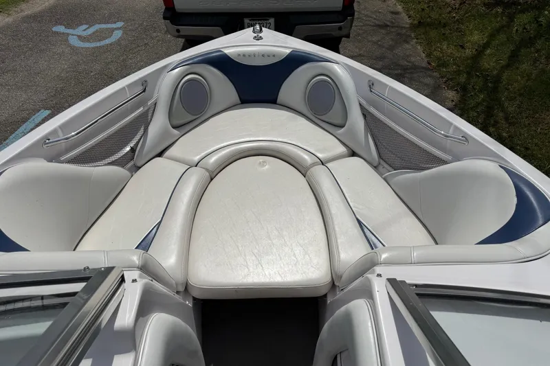 Slide: The Image of 2004 Correct Craft Air Nautique 226 boat interior with white and blue seating. - 6