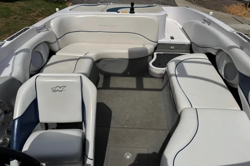 Slide: The Image of 2004 Correct Craft Air Nautique 226 boat interior with white seating and gray flooring. - 7