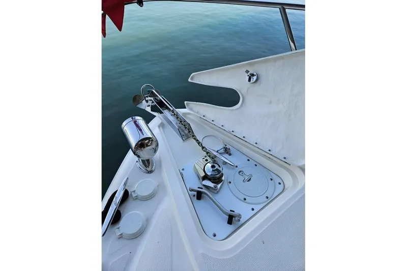 Slide: The Image of 2006 Sea Ray 290 Sundancer boat anchor system with chrome fittings and calm water backdrop. - 17