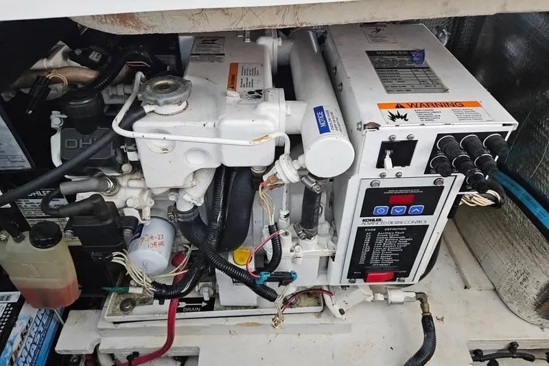 Slide: The Image of Engine compartment of a 2006 Sea Ray 290 Sundancer boat, featuring mechanical components. - 19