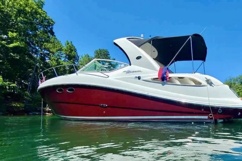 Slide: The Image of 2006 Sea Ray 290 Sundancer boat on water, red and white design, sunny day. - 3