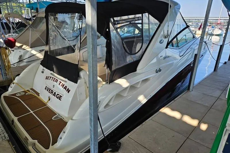 Slide: The Image of 2006 Sea Ray 290 Sundancer docked, featuring "Better Than Average" sign. - 4