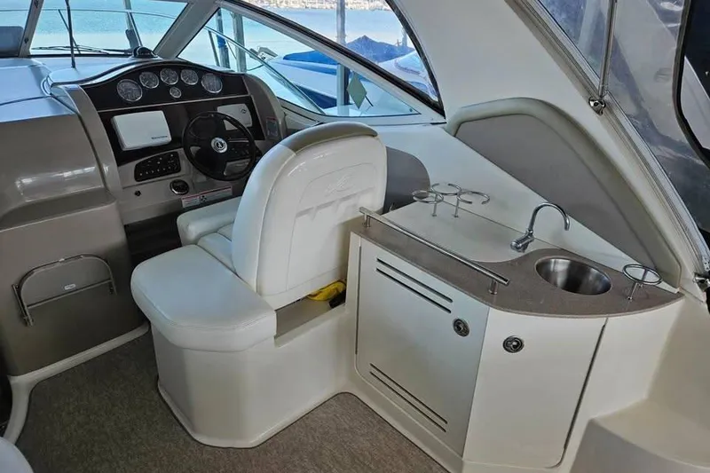 Slide: The Image of 2006 Sea Ray 290 Sundancer cockpit with helm, sink, and seating. - 6