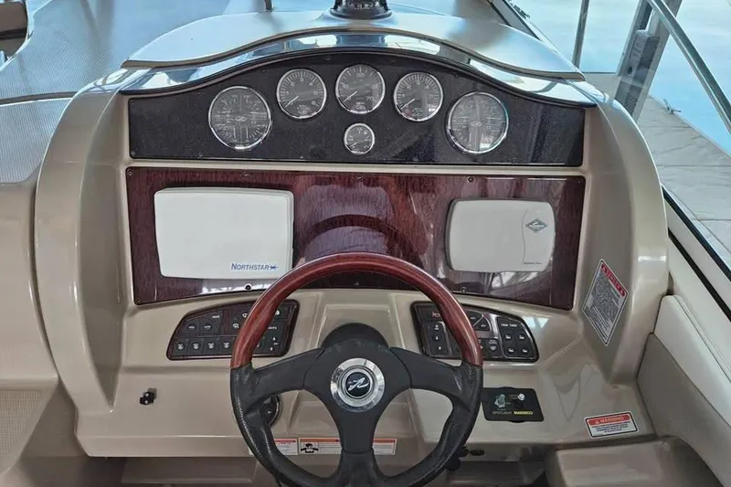 Slide: The Image of 2006 Sea Ray 290 Sundancer dashboard with gauges and steering wheel. - 7
