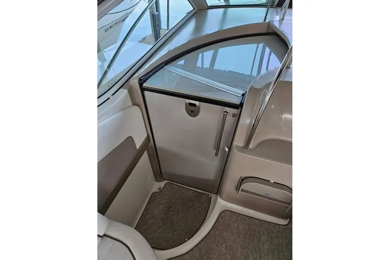 Slide: The Image of 2006 Sea Ray 290 Sundancer cabin entrance with sleek design and modern interior. - 8