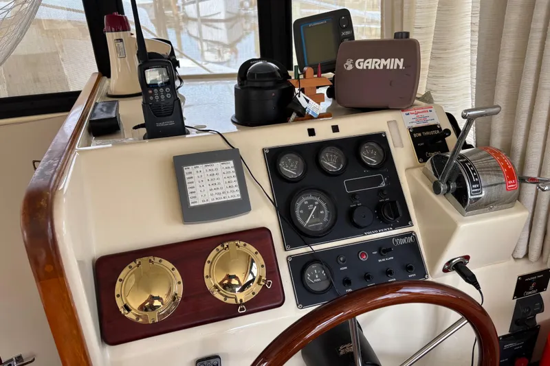Slide: The Image of 2004 Camano Trawler helm with Garmin navigation, gauges, and controls. - 19