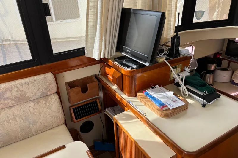 Slide: The Image of Interior of a 2004 Camano Trawler with TV, radio, and cozy seating area. - 21