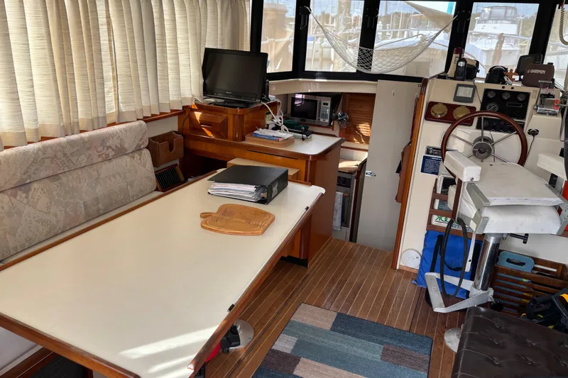 Slide: The Image of Interior of a 2004 Camano Trawler with helm, seating, and navigation equipment. - 24